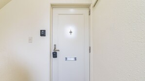 A white door with a keyhole, a doorbell, and a mail slot. - AS7 Building (Sumida-ku)