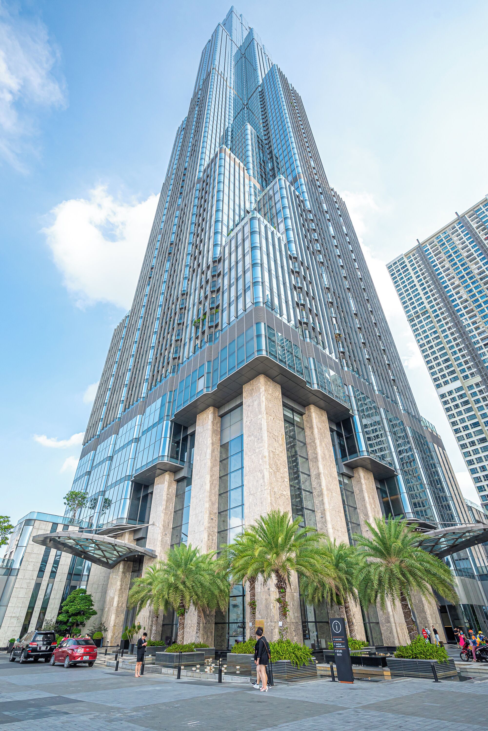 A tall, modern skyscraper with a glass facade and a prominent entrance.