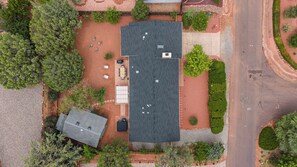 An aerial view of a property with a large building, a parking area, and surrounding greenery. - West Sedona retreat with 4 bedrooms, hot tub, and Red Rock views. (Sedona)