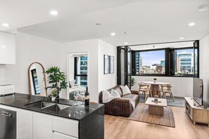 A modern apartment with a kitchen, dining area, and living room. - Luxury Meets Lifestyle (Fortitude Valley)