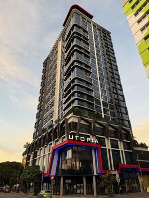A tall, modern building with a prominent 'UTOPIA' sign at the base. - Luxury Meets Lifestyle (Fortitude Valley)