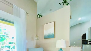 A living room with a sofa, a lamp, and a painting on the wall. - Coastal Paradise Near the Beach - Private Heated Pool - 4BR Marco Island Retreat (Marco Island)
