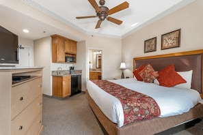 A hotel room with a bed, a ceiling fan, a kitchenette, and a television. - Charming resort at the mountain at Lake Tahoe, near casinos - LABOR DAY week (Stateline)