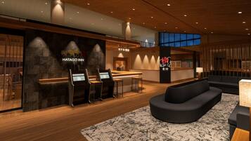 A reception area with a reception desk, seating, and a staircase leading to an upper level.