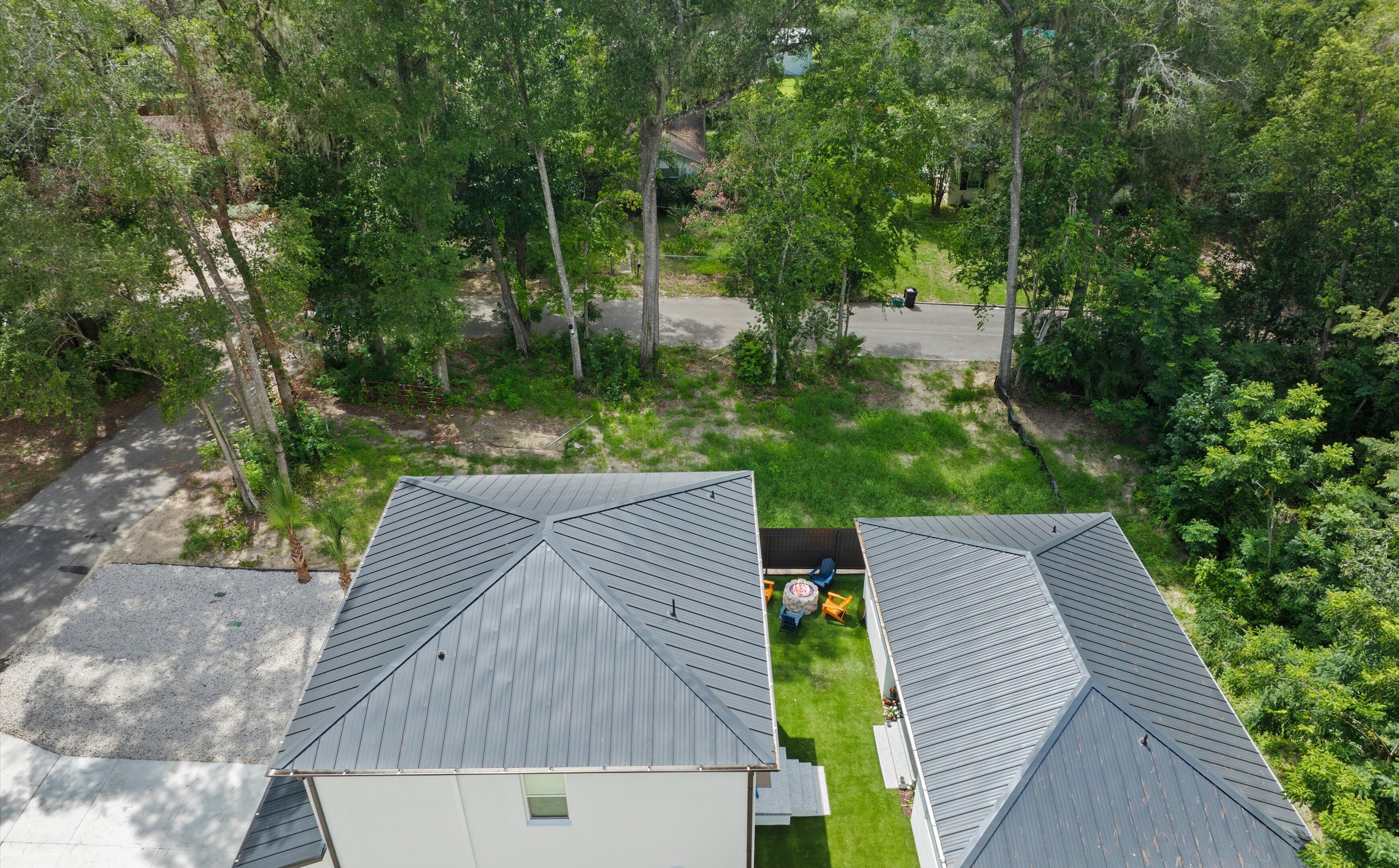 A residential property with a sloped roof, a paved driveway, and a well-maintained lawn.
