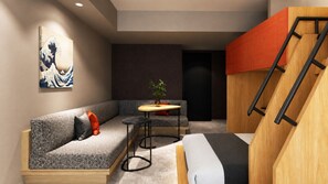 A compact room with a sofa, a small table, a bed, and a staircase. - Minn Ueno Iriya East (Taito)