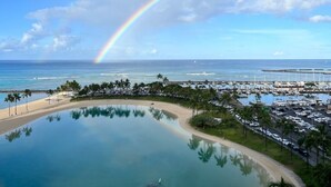 A resort with a large pool, a beach, and a marina. - Waikiki | Resort Lagoon Stay | Pools & Beach Access (Honolulu)