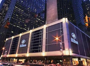 A Hilton hotel with a modern facade, large windows, and a prominent vertical column.