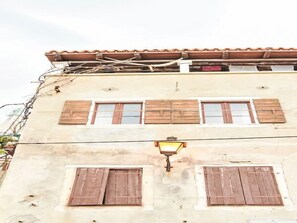 A building with two windows and a single light fixture. - Rovinj, Magic Peninsula by Interhome (Rovinj)