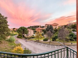 A residential area with a curved road, houses, and trees. - Stella Marina by Interhome (Pietra Ligure)