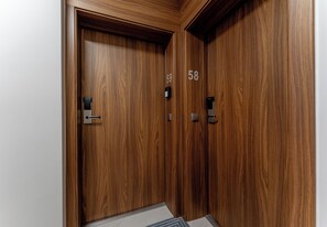 A wooden door with a number '58' and a doorbell. - Podgórze Boutique Studio (Kraków)