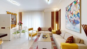 A modern living room with a sofa, coffee table, and dining area. - Serene 2-bedroom apartment with AC in vibrant Amman (Amman)