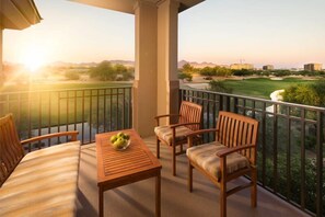 A balcony with a table and chairs, overlooking a golf course. - Scottsdale | Romantic Desert Escape | Pool + Golf (Scottsdale)