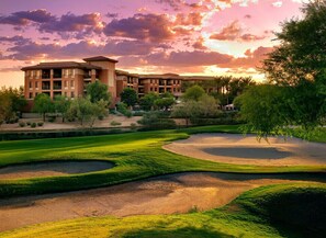 A golf course with bunkers and a large building in the background. - Scottsdale | Romantic Desert Escape | Pool + Golf (Scottsdale)
