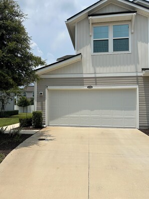 A two-story house with a white garage door and a number '11916' on the garage door. - Fantastic 2-bedroom townhome  Jacksonville (Jacksonville)