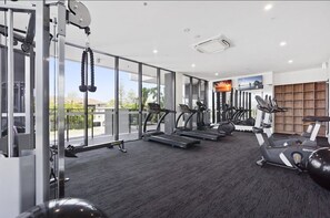 A gym with treadmills, elliptical machines, and free weights. - Sandbar 80 - (2BR/2BA) (Gold Coast)