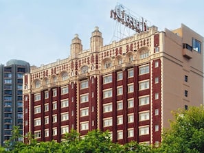 A large, historic building with a prominent sign reading "Lions." It features a classic architectural style with ornate detailing and multiple windows. - Seattle | Peaceful Courtyard Stay | Gym + Walkable (Seattle)