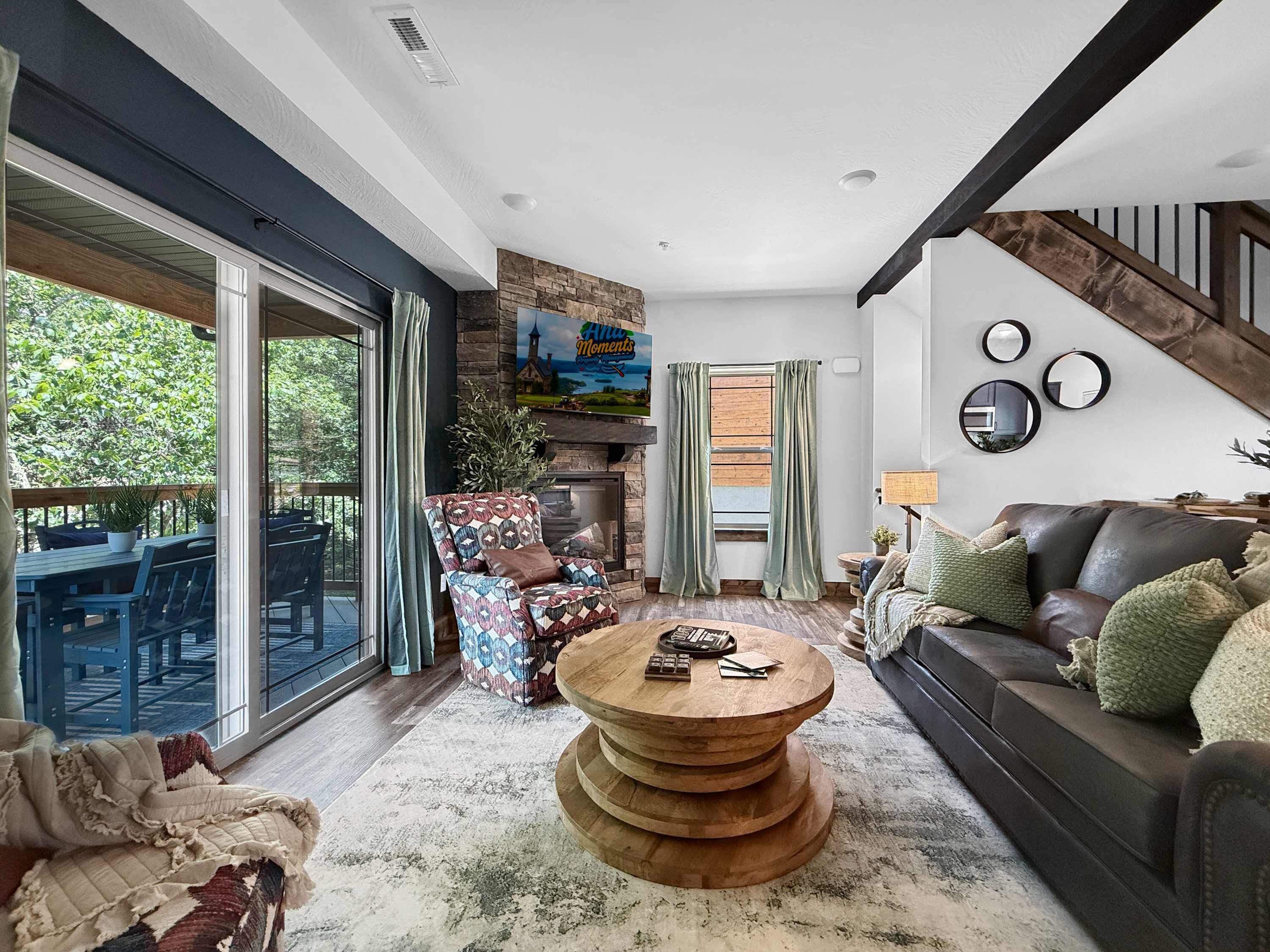 A spacious living room with a large sliding glass door leading to an outdoor area, a fireplace, and a modern coffee table.