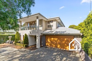 A two-story house with a covered garage, a balcony, and a landscaped front yard. - The Sorrento Sojourn *1 NIGHT FREE* Luxury Spa Retreat (Sorrento)