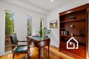 A room with a wooden desk, a green chair, a bookshelf, and a window with a view of greenery. - The Sorrento Sojourn *1 NIGHT FREE* Luxury Spa Retreat (Sorrento)