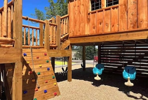 A wooden play structure with climbing elements and swings. - Beautiful Lake View, spacious, pool, pickleball (Kimberling City)