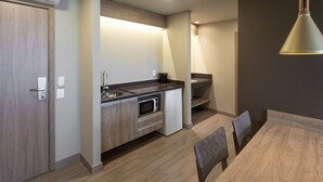 A modern kitchen with a built-in microwave, a sink, and a coffee maker.