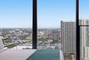 A high-rise building with multiple floors, a clear sky, and a distant view of a cityscape. - 38th Floor E11EVEN Retreat w/ Skyline Views (Miami)
