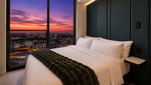 A bedroom with a large window, a bed, and a city view at dusk. - Luxury 26th Floor Studio E11EVEN w/ Rooftop Pool (Miami)