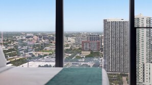 A high-rise building with multiple floors, a clear sky, and a distant view of a cityscape. - 40th Floor E11EVEN Studio w/ Skyline Views (Miami)