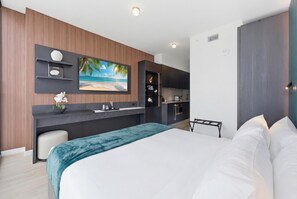 A modern hotel room with a bed, a desk, and a kitchen area. - 40th Floor E11EVEN Studio w/ Skyline Views (Miami)