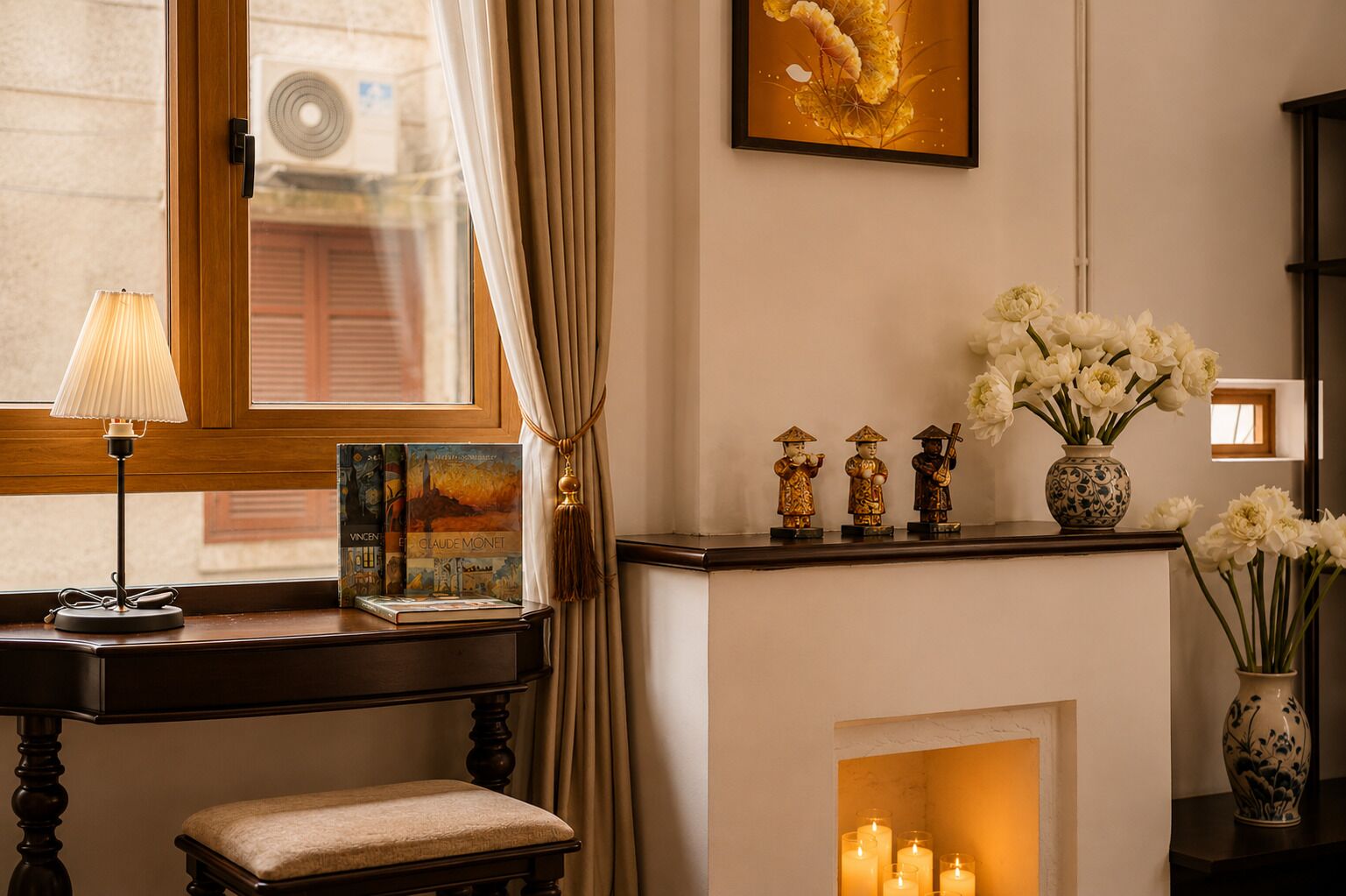 A room with a fireplace, a table with a lamp, a framed picture, and decorative items.
