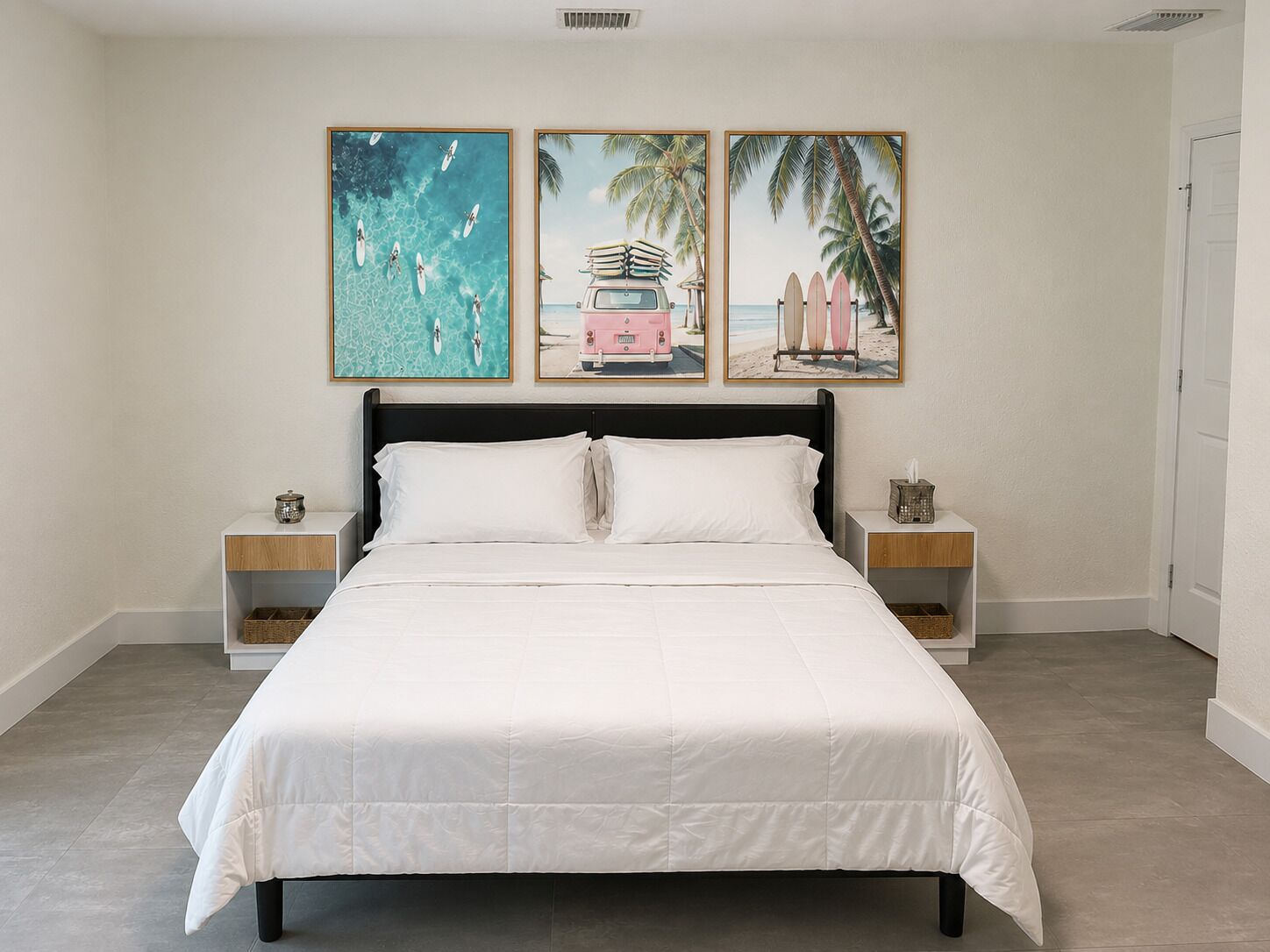 A bedroom with a bed, nightstands, and wall art.