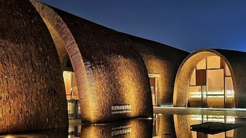 A modern building with cylindrical structures and reflective surfaces.