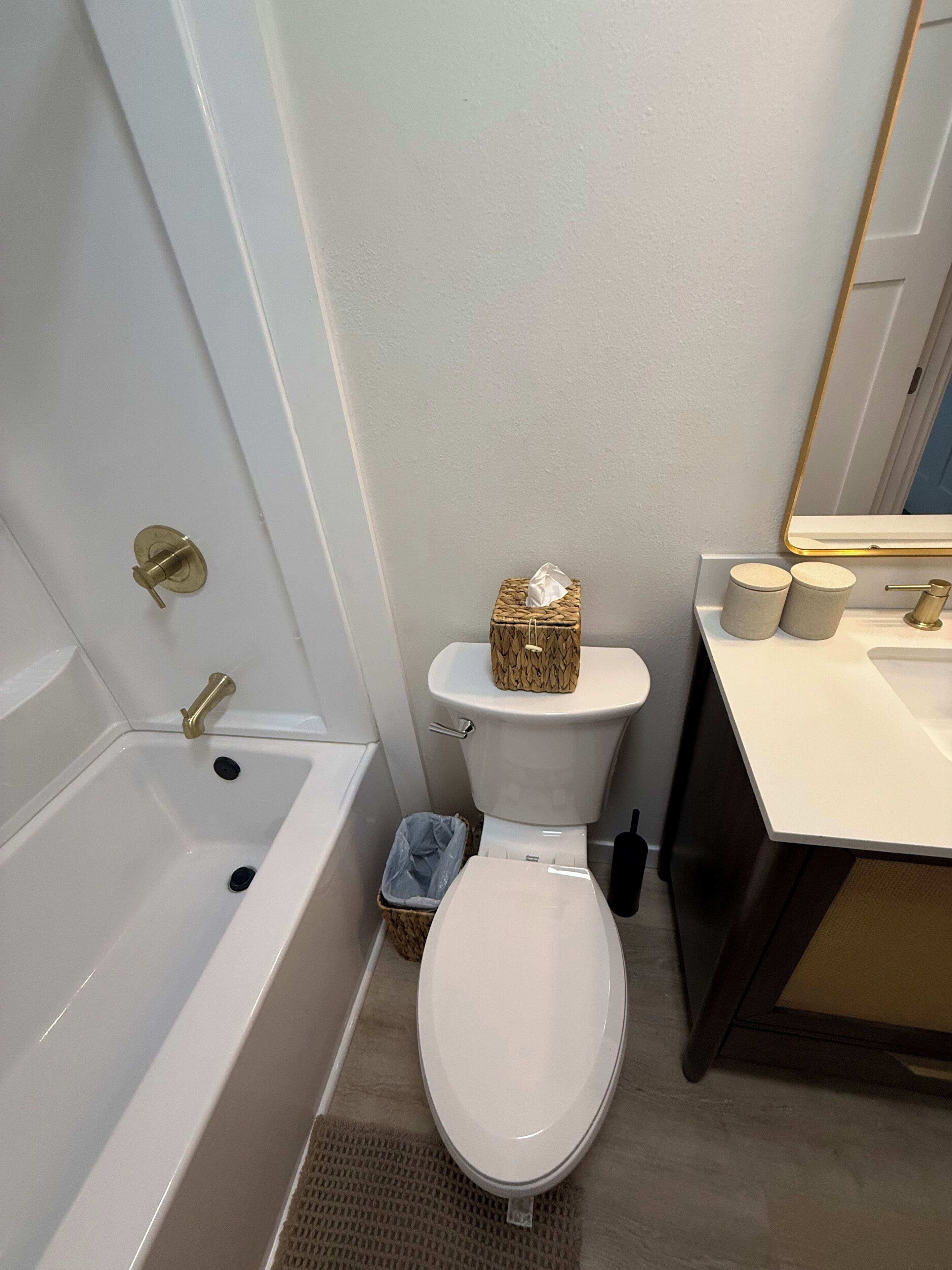 A bathroom with a bathtub, toilet, and sink.