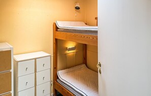 A bunk bed with a headboard, a bedside table, and a small cabinet with drawers. - 2 bedroom gorgeous home in Tranekær (Tranekær)