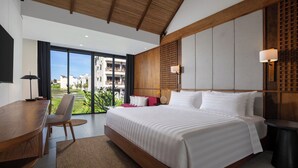 Habitación de hotel moderna con una cama grande, un escritorio y vistas a una zona residencial.