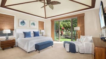 A bedroom with a bed, a bench, a desk, and a view of the outdoors.