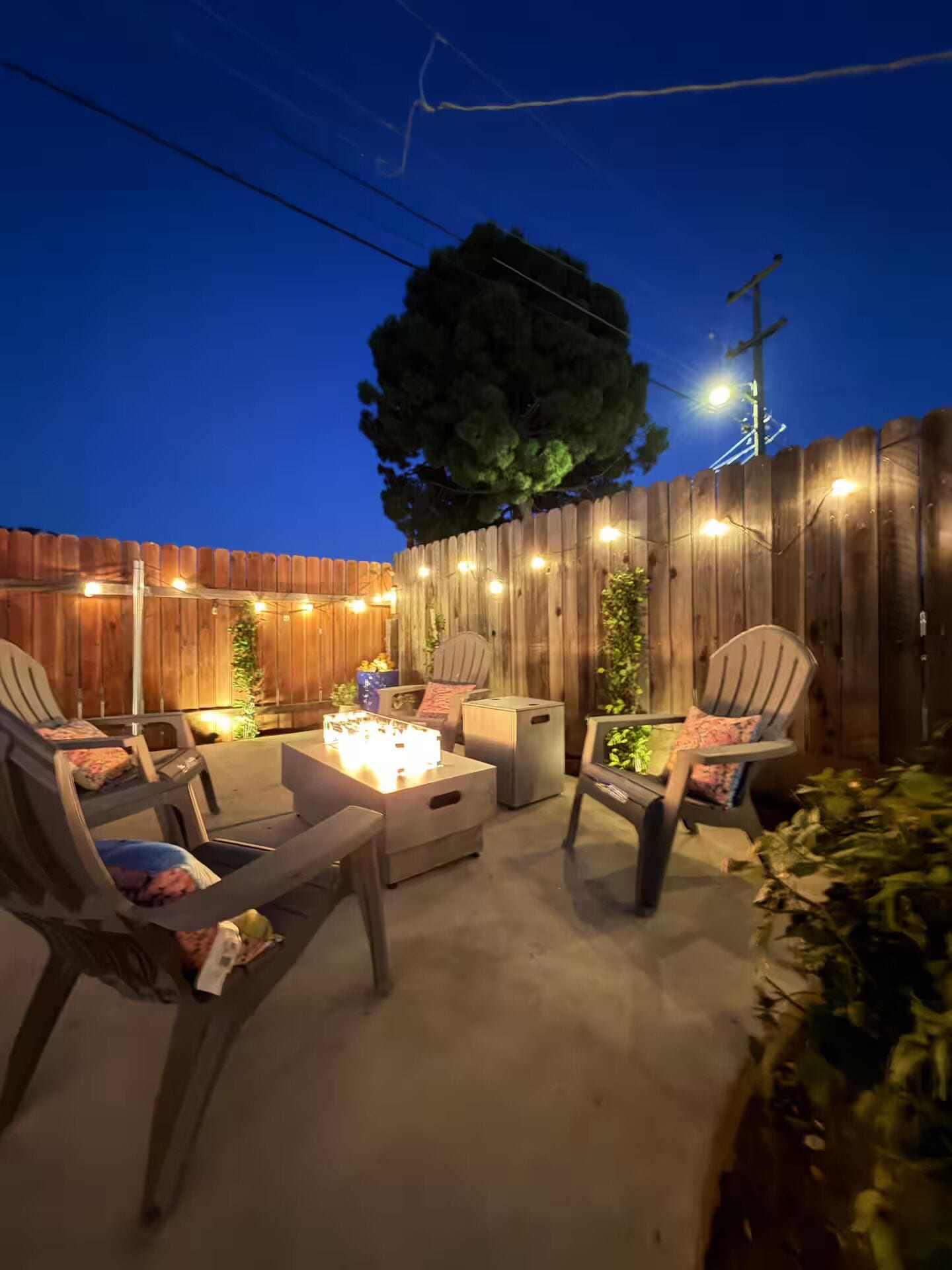 An outdoor patio area with seating and a fire pit.