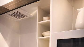 A kitchen with a stainless steel sink, a microwave, and a built-in oven.