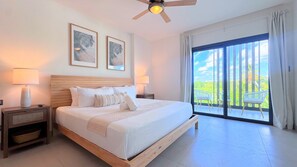 A spacious bedroom with a large bed, two bedside lamps, and a ceiling fan. - Peaceful Pool View Walk to Fun Beach Dine Shop (Punta Cana)