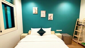 A bedroom with a teal accent wall, a bed with white bedding, and three wall-mounted artworks. - Sweet House Phu Quoc (Phu Quoc)