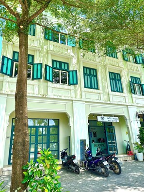 A building with multiple windows and a sign for 'Sweet House PHU QUOC'.
