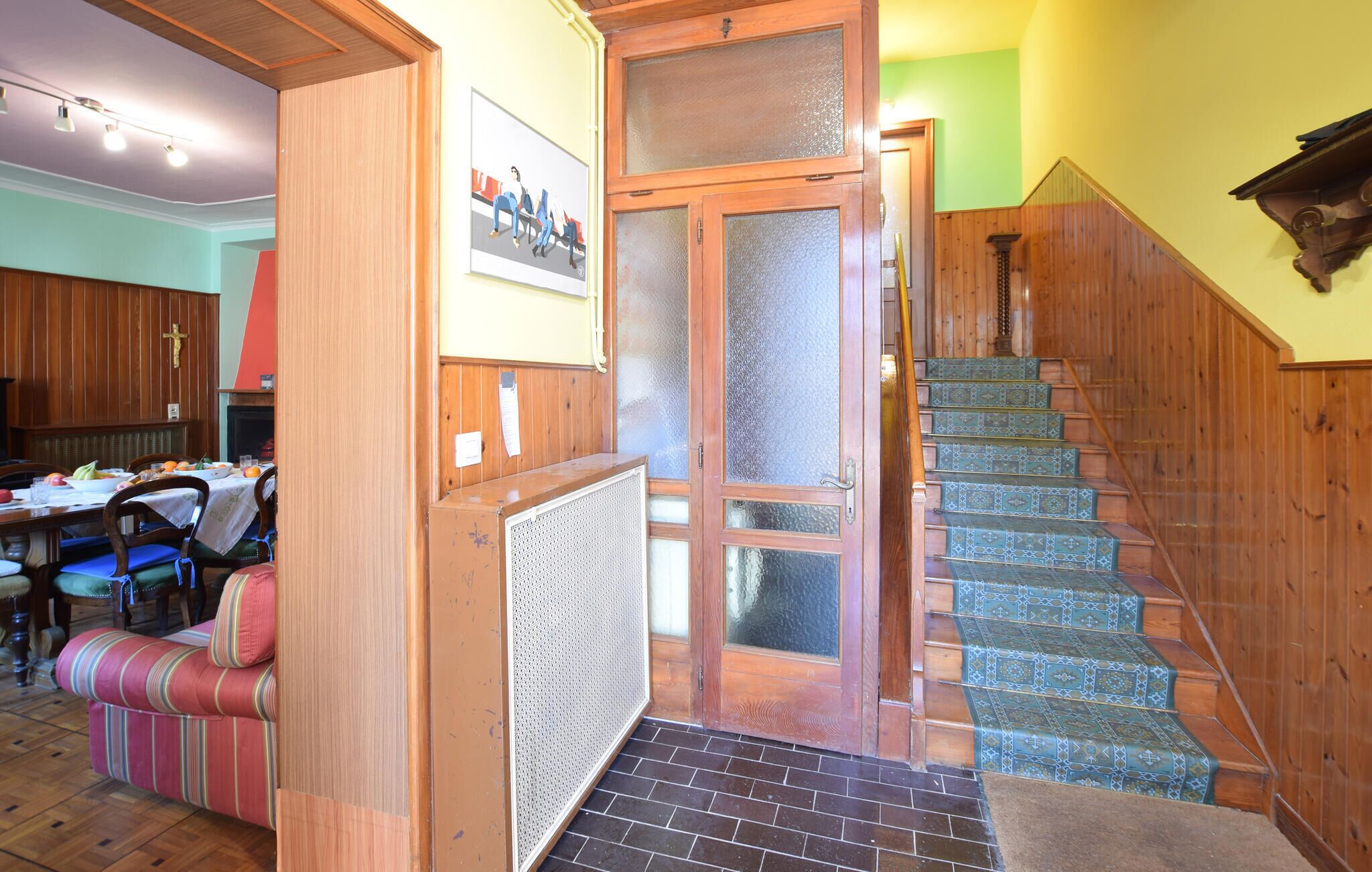 A staircase with patterned steps leading to a door with frosted glass panels.