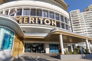 A modern hotel entrance with a prominent 'MERITON' sign, a covered walkway, and a glass facade. - New L63 Hill River CBD View&Pool & Sauna (Surfers Paradise)