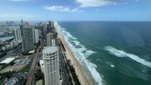 A coastal cityscape with high-rise buildings, a beach, and a clear sky. - Meriton L47 with SeaViews and CarPark (Surfers Paradise)