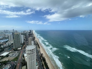 A coastal cityscape with high-rise buildings, a beach, and a clear sky. - Meriton L47 with SeaViews and CarPark (Surfers Paradise)