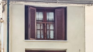 A building with a window featuring wooden shutters and a white sill. - 2 bedroom gorgeous home in Viareggio (Viareggio)