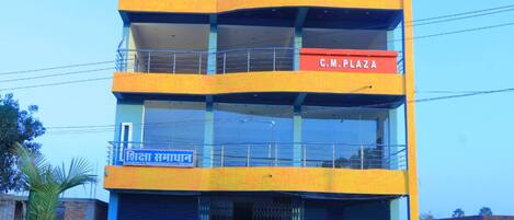 A multi-story building with a sign for 'C.M. Plaza' on the top floor.
