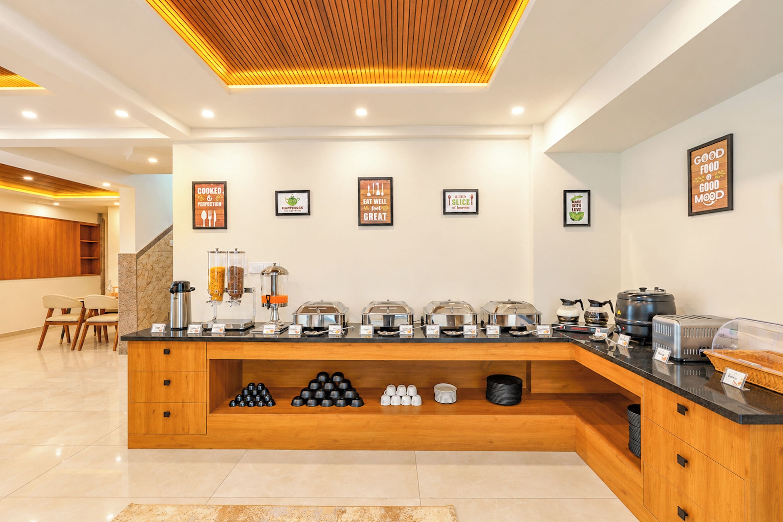 A modern breakfast bar with a variety of food options and a coffee station.