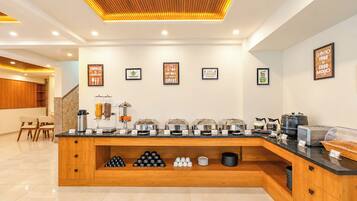 A modern breakfast bar with a variety of food options and a coffee station.